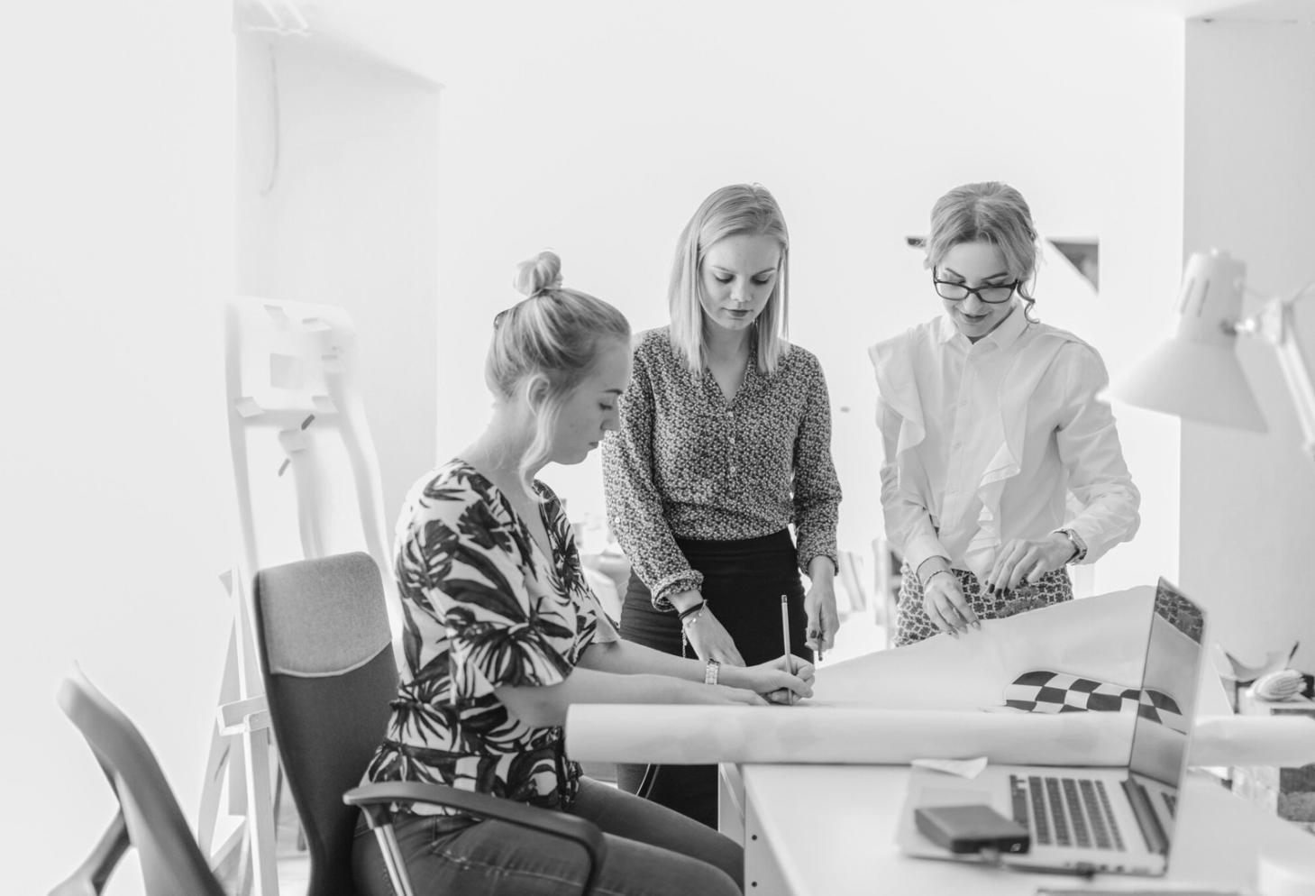Professional team collaborating on financial modeling in modern office environment